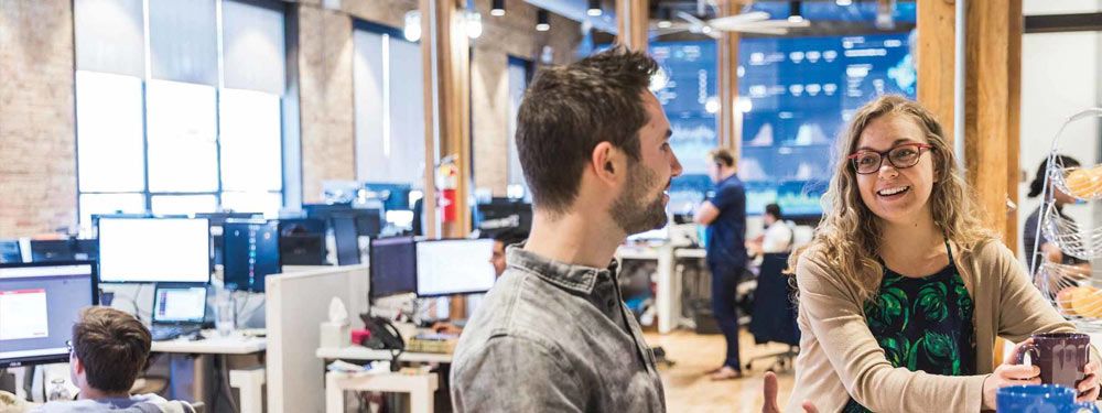 Girl and boy talking in the Telnyx office