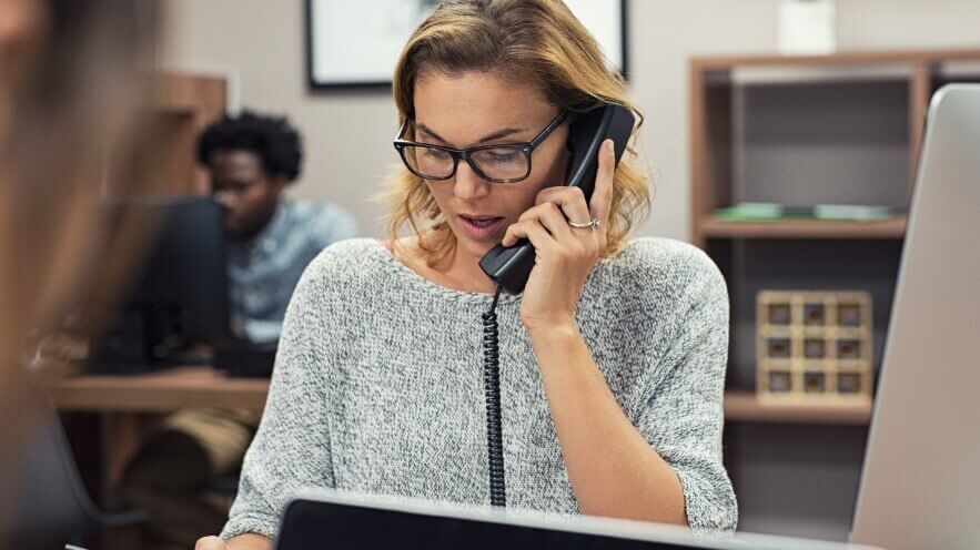 woman talking on non-fixed VoIP phone